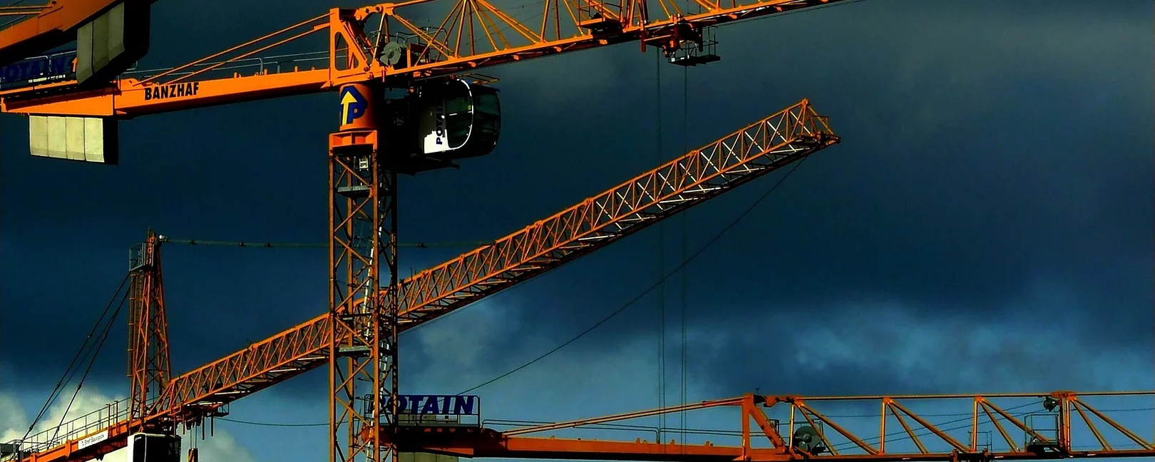 Baukräne vor dunklen Wolken
